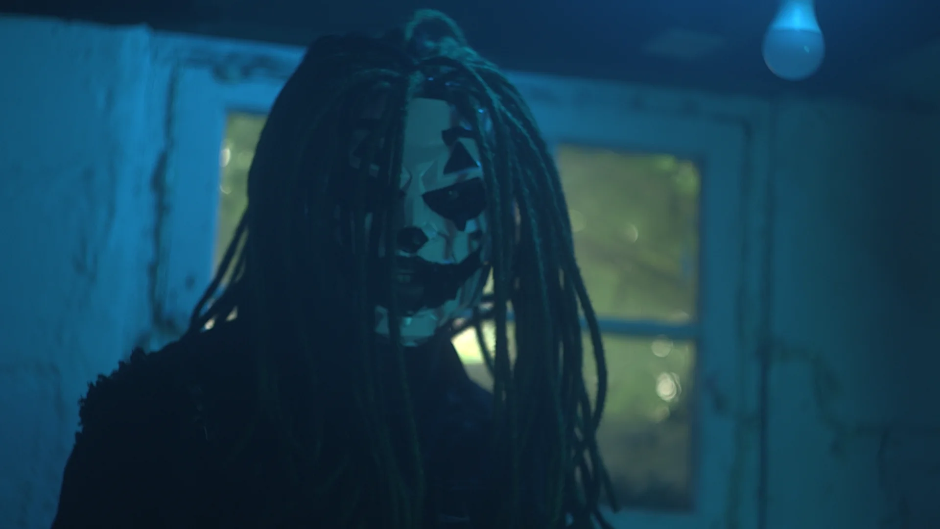 Front portrait of masked Jai Ghost in the basement
